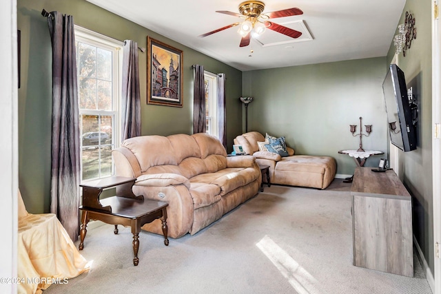 carpeted living room with ceiling fan