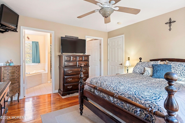 bedroom with ensuite bathroom, hardwood / wood-style flooring, and ceiling fan