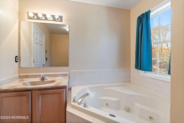 bathroom with vanity and tiled bath