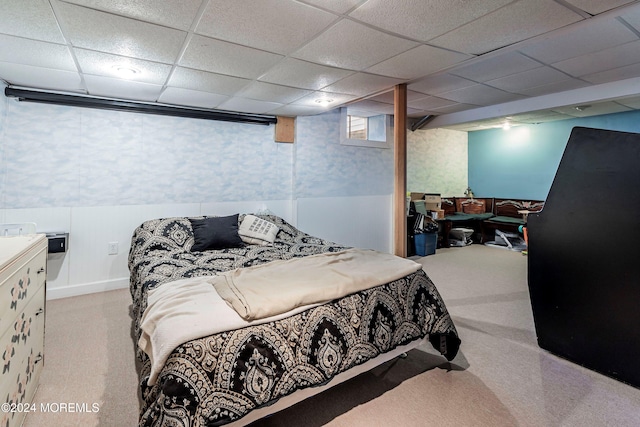 carpeted bedroom with a paneled ceiling