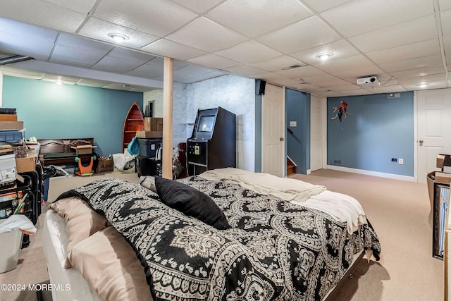 bedroom with a drop ceiling and carpet