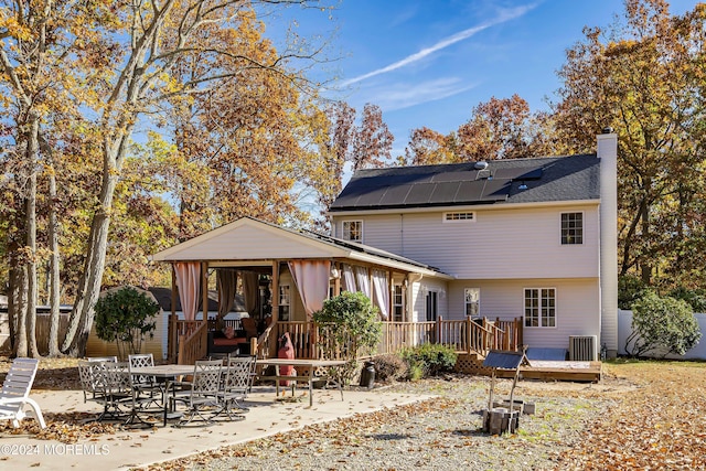 back of property with a patio and a wooden deck