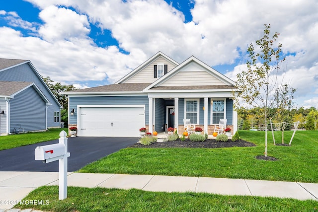 craftsman-style home with covered porch, a front yard, and a garage