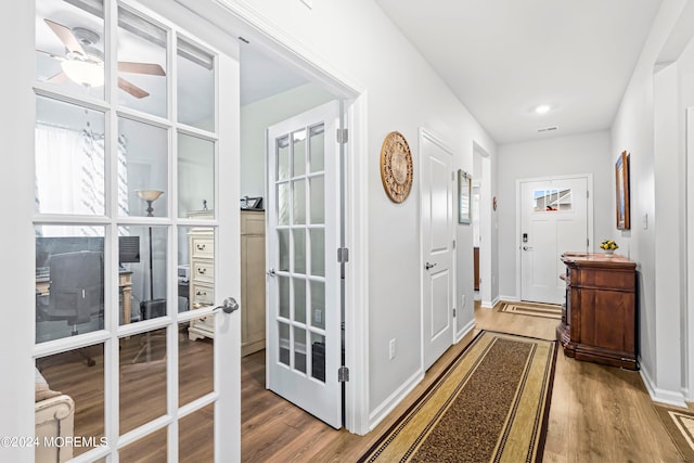 doorway to outside featuring french doors, ceiling fan, and hardwood / wood-style flooring