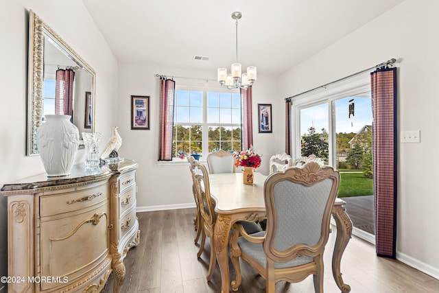 dining room with a notable chandelier and hardwood / wood-style flooring