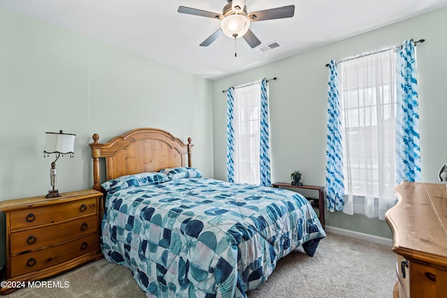 bedroom with ceiling fan and light colored carpet