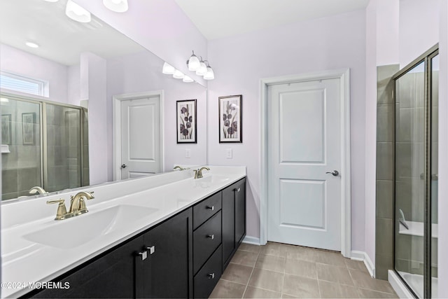 bathroom featuring vanity, tile patterned floors, and a shower with door