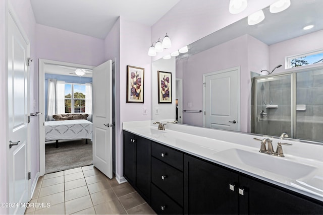 bathroom with vanity, a shower with shower door, and tile patterned floors