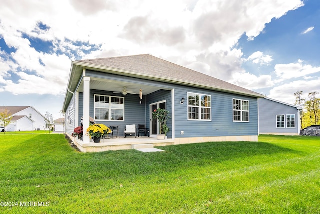 back of property featuring ceiling fan, a patio, and a lawn