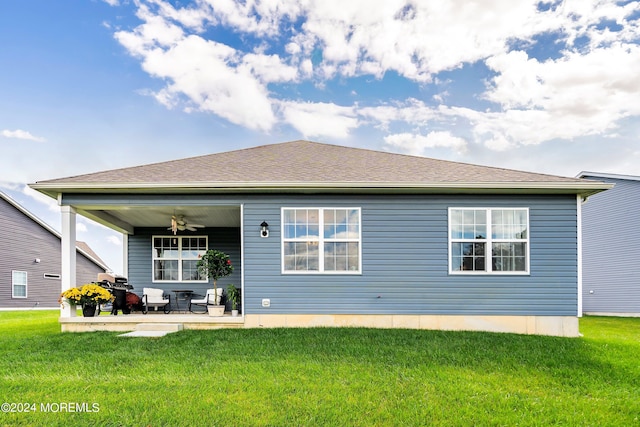 rear view of house featuring a patio area, ceiling fan, and a lawn