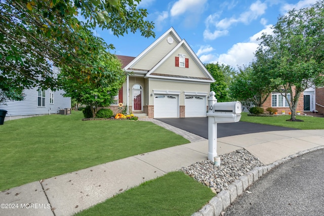 view of front of home with a front yard, a garage, and cooling unit