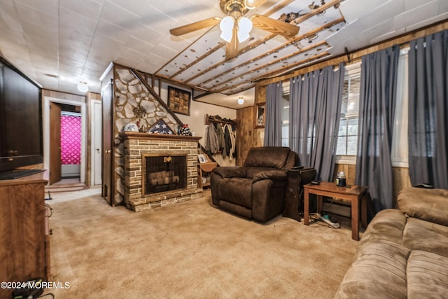 living room with ceiling fan, carpet floors, and a fireplace