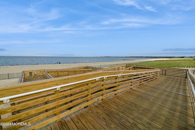 exterior space featuring a water view and a beach view