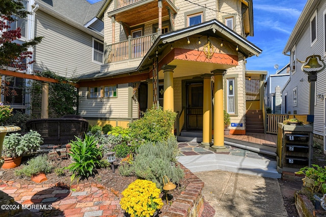 view of exterior entry featuring a balcony