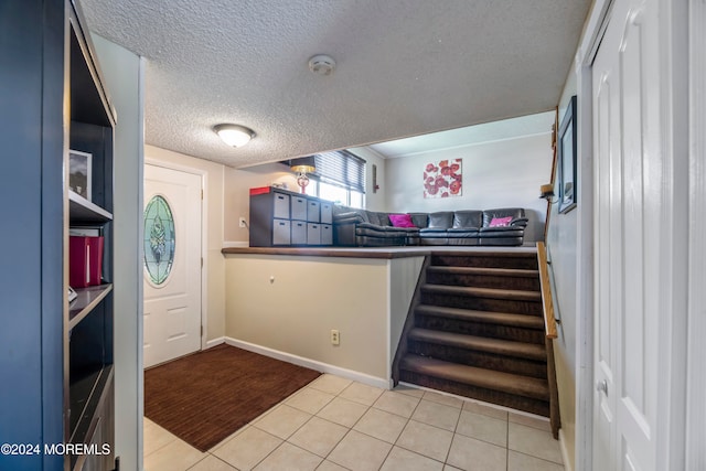 kitchen featuring a textured ceiling and light hardwood / wood-style flooring