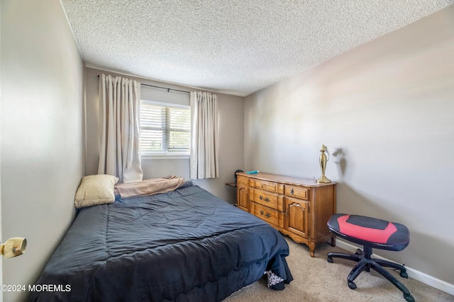 bedroom with light carpet and a textured ceiling