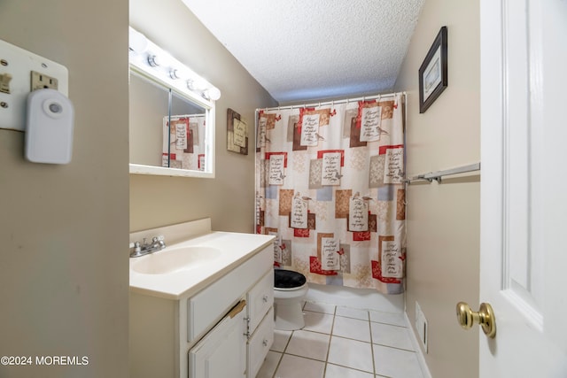 bathroom with toilet, vanity, curtained shower, and a textured ceiling