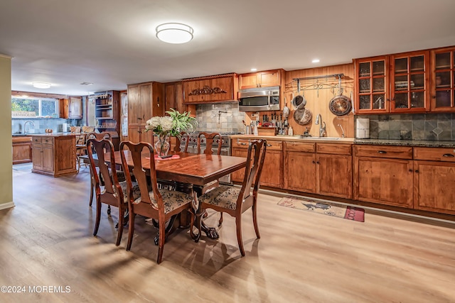 dining space featuring recessed lighting and light wood-style flooring