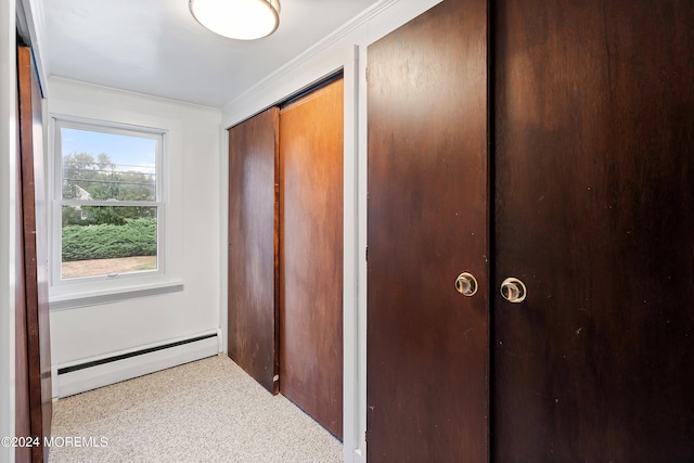 hall with a baseboard radiator and crown molding