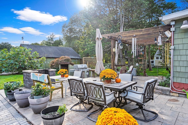 view of patio with outdoor dining space, grilling area, and a pergola