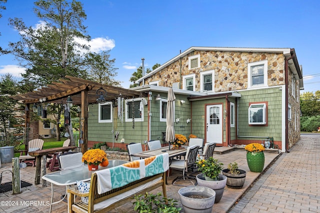 back of property with a patio and a pergola