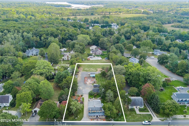 birds eye view of property featuring a wooded view