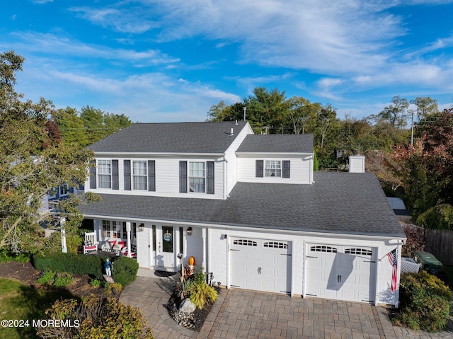 46 Markwood Dr, Howell, NJ 07731 - view of front of property featuring a garage, a shingled roof, covered porch, driveway, and a chimney