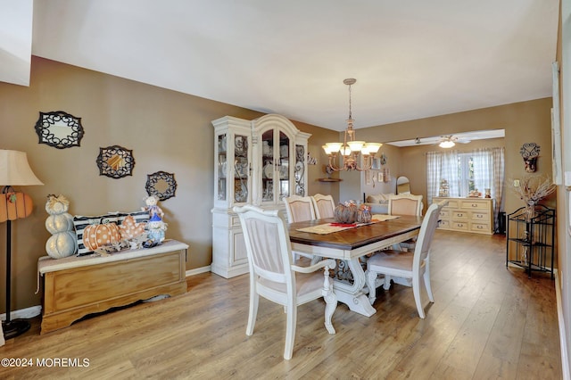 46 Markwood Dr, Howell, NJ 07731 - dining space featuring baseboards, light wood-type flooring, and ceiling fan with notable chandelier