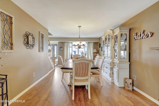 dining space featuring a chandelier and light hardwood / wood-style flooring