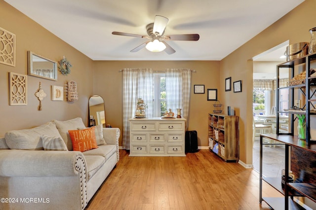 46 Markwood Dr, Howell, NJ 07731 - living area featuring light wood finished floors, ceiling fan, baseboards, and a healthy amount of sunlight