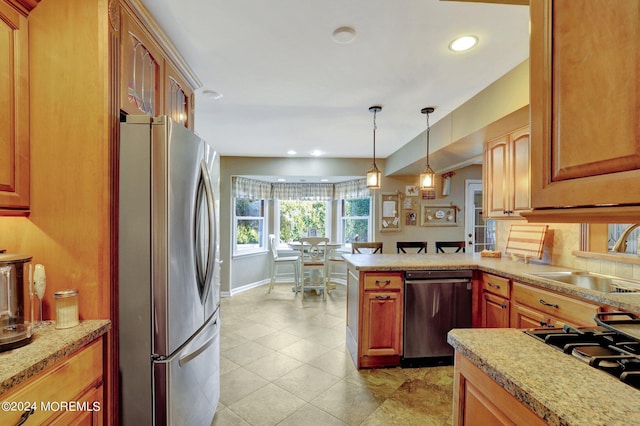 kitchen featuring light tile patterned flooring, sink, decorative light fixtures, appliances with stainless steel finishes, and kitchen peninsula