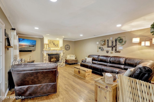 living room featuring crown molding and light hardwood / wood-style floors