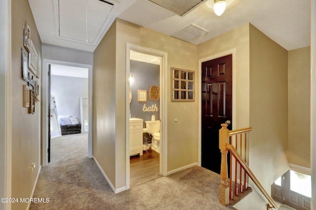 corridor featuring light colored carpet