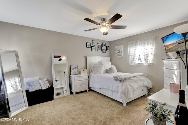 bedroom featuring light colored carpet and ceiling fan