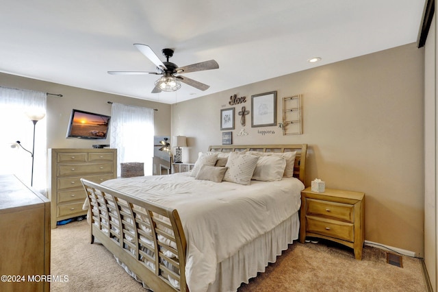 bedroom with light colored carpet and ceiling fan