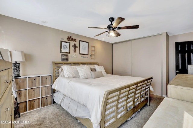 bedroom with carpet, ceiling fan, and a closet