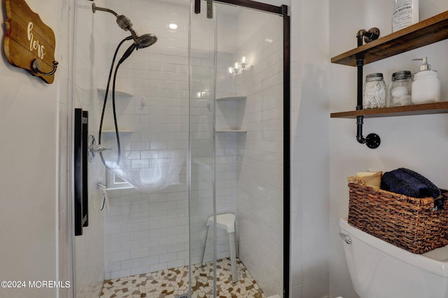 bathroom featuring an enclosed shower and toilet