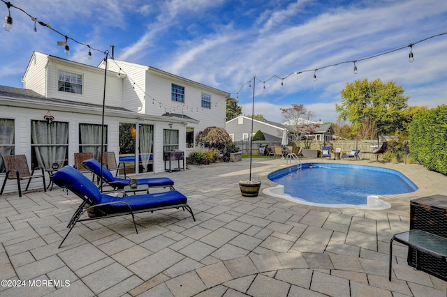 view of swimming pool featuring a patio area