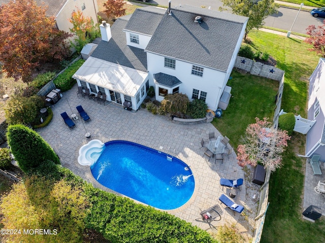 view of pool with a patio and a lawn