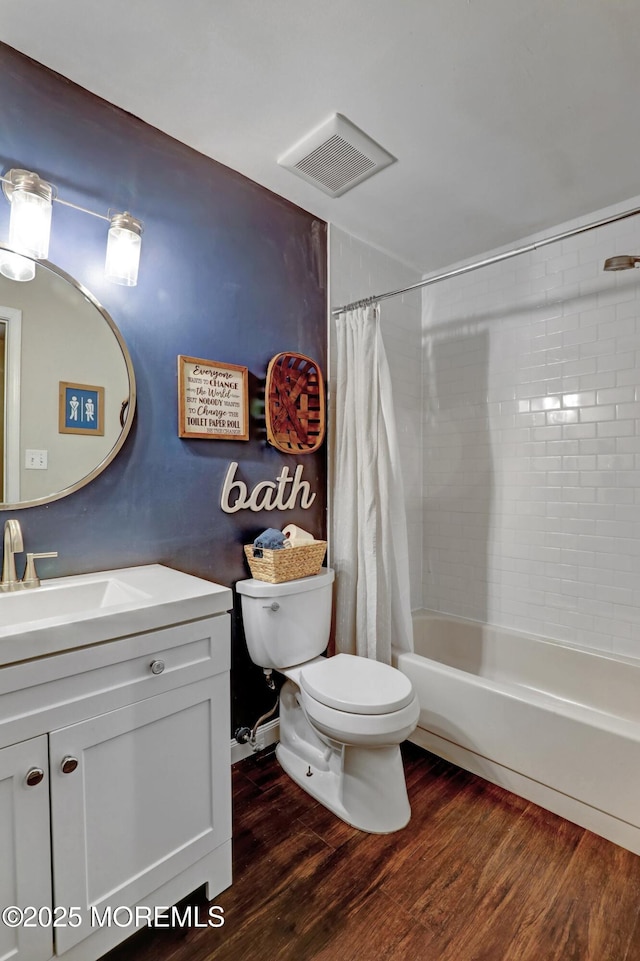 full bathroom with hardwood / wood-style flooring, vanity, toilet, and shower / bath combo with shower curtain