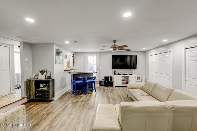 living room featuring light wood-type flooring and ceiling fan