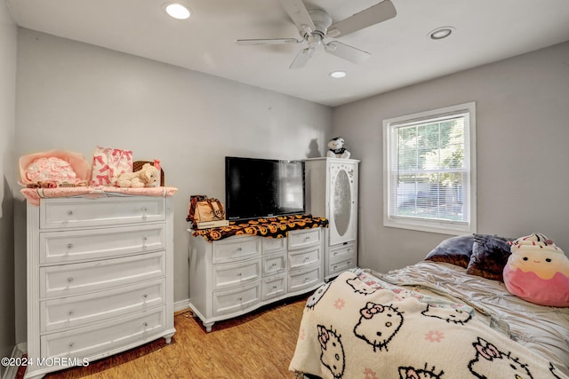 bedroom with ceiling fan and light hardwood / wood-style floors