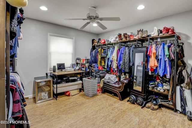 walk in closet with hardwood / wood-style flooring and ceiling fan