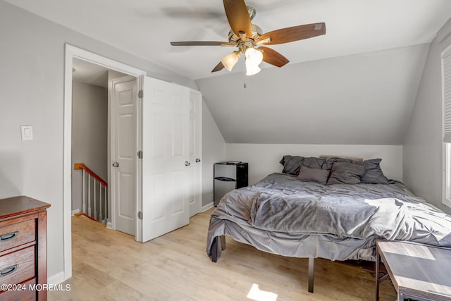 bedroom featuring ceiling fan, light hardwood / wood-style flooring, and lofted ceiling