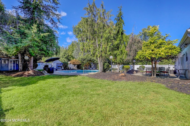 view of yard with a fenced in pool and a patio area