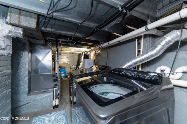 clothes washing area featuring washer / dryer