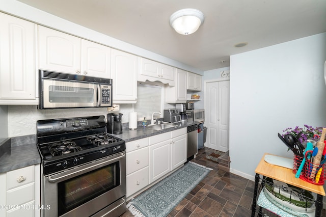 kitchen with white cabinetry, sink, stainless steel appliances, and tasteful backsplash