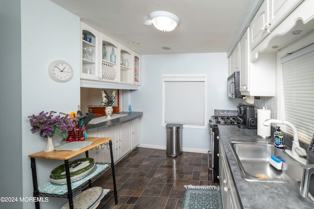 kitchen with white cabinets, appliances with stainless steel finishes, and sink