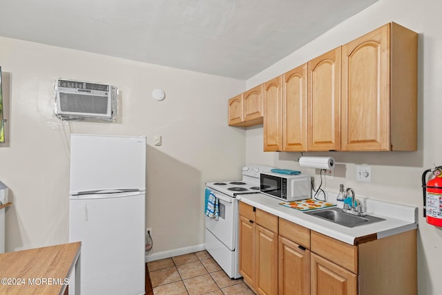 kitchen featuring light brown cabinets, light tile patterned floors, sink, white appliances, and a wall mounted air conditioner