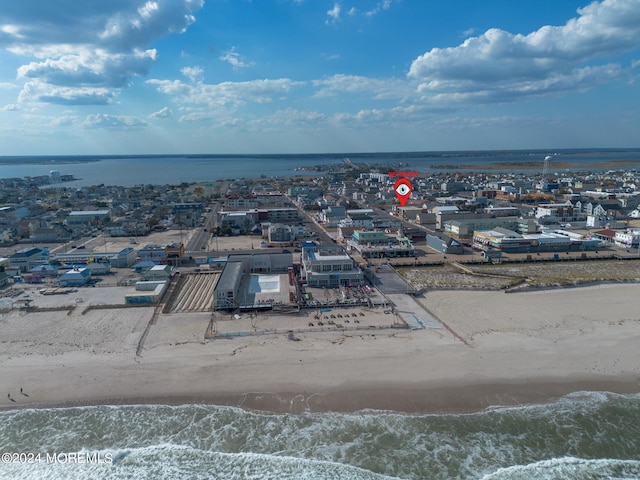 drone / aerial view with a water view and a view of the beach